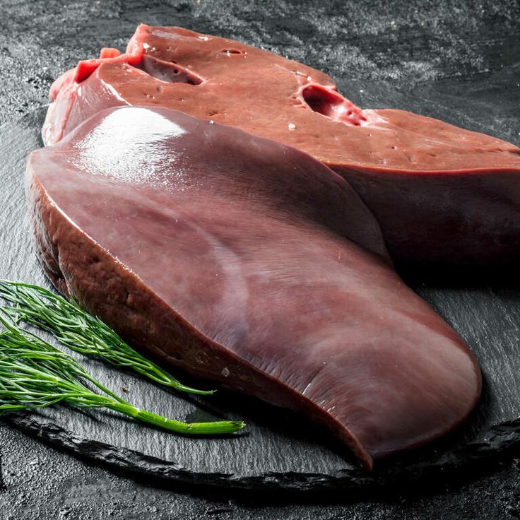 Raw liver with dill on a stone Board.